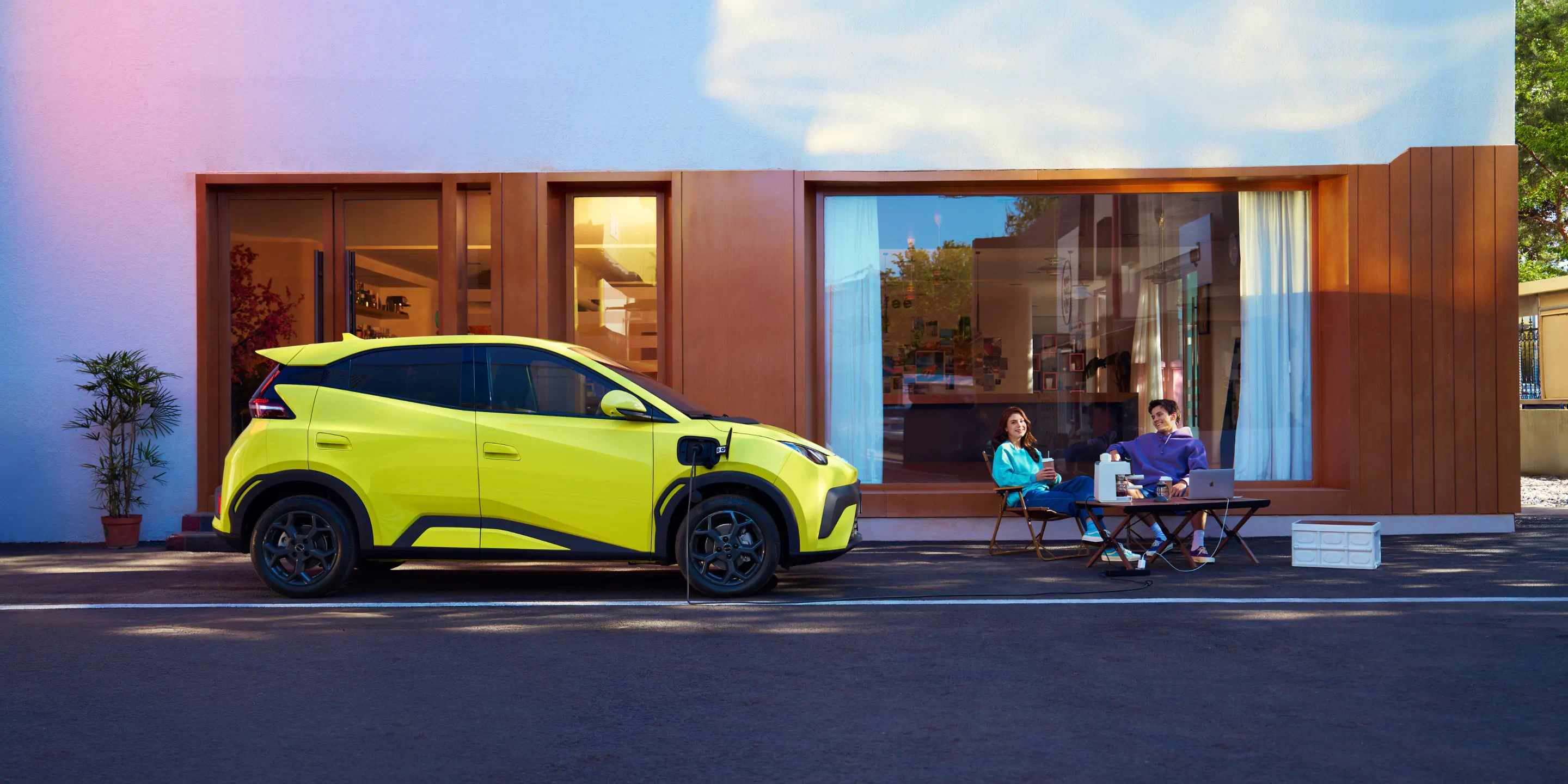 BYD Dolphin Surf charging outside a modern home